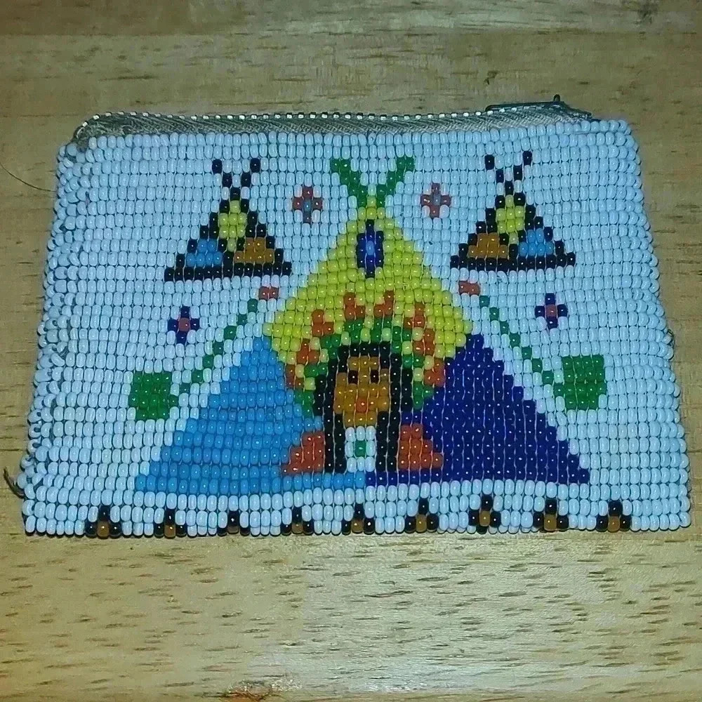 Native American imagery bead work on vintage leather coin purse.
